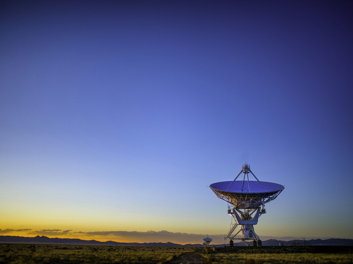 A satellite dish at dusk